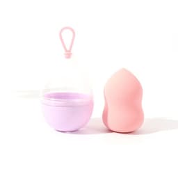 A pink gourd makeup sponge next to a transparent lanyard case with a purple base. The case has a loop for hanging.