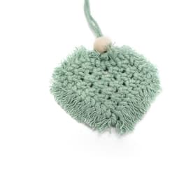 A heart-shaped car hanging ornament in a soft mint green with a textured fringe and a wooden bead.
