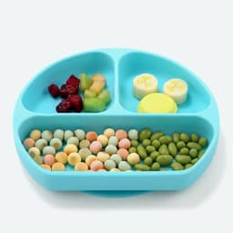 A silicone baby feeding plate in a light blue colour, featuring three sections filled with various foods.