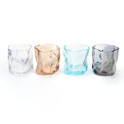 Four irregular-shaped whiskey cups in clear, amber, light blue, and grey colours, featuring a logo on each.