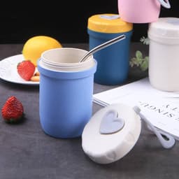 A drink bottle in pastel blue with a heart-shaped lid and a straw, alongside other colourful travel cups.