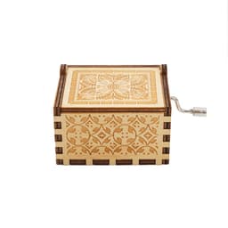 A wooden music box with intricate carvings, featuring a small metal handle on the side.