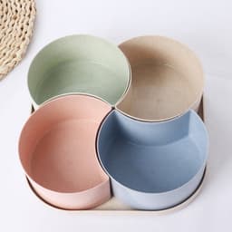 A 4-compartment snack tray in pastel colours, featuring green, pink, blue, and beige bowls on a beige base.