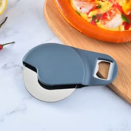 A grey round pizza cutter with a built-in bottle opener, placed next to a freshly baked pizza on a wooden board.