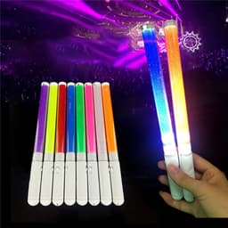 Handheld LED glow sticks in various colours, featuring white handles and glowing brightly against a concert backdrop.