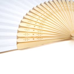 A traditional paper folding fan with bamboo ribs, featuring a white design and decorative cutouts on the ribs.