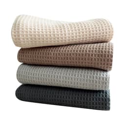 Four stacks of cotton waffle absorbent kitchen cloths in beige, brown, grey, and charcoal colours. The image includes a logo.