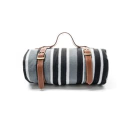 A rolled fleece picnic blanket in grey and black stripes, secured with two brown leather straps.