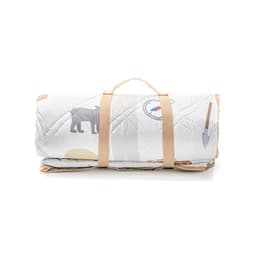 A rolled-up picnic blanket with a carrying strap, featuring a patterned design in neutral tones.