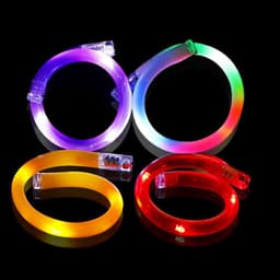 Four LED luminous bracelets in purple, yellow, red, and multicoloured, each emitting vibrant light.