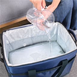 A blue insulated cooler bag with a person pouring water into it. The interior is lined and waterproof.
