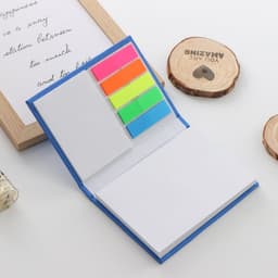 A hard cover sticky note memo pad with a blue exterior and bright neon sticky notes in pink, yellow, green, and orange.