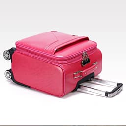 A pink wheeled suitcase with a retractable handle and dual wheels, featuring a stylish design and a logo.