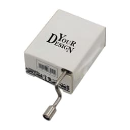 A hand crank music box in a white and black box, featuring a metal crank handle. The box has a branding logo.