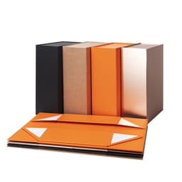 A selection of custom foldable paper gift packaging boxes in black, brown, orange, and metallic finishes.
