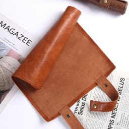 A foldable pu leather dice bag in a rich brown colour with a smooth finish and snap fasteners.