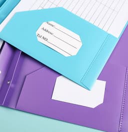 A two-pocket plastic folder in purple and blue, featuring pockets for labels or information.