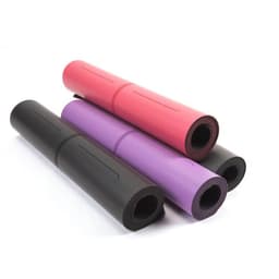 Four rolled yoga mats in black, pink, and purple, showcasing varying colours and textures. The mats feature a logo.