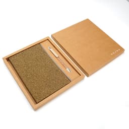 A brown biodegradable notebook with a textured cover, accompanied by a wooden pen, presented in a matching gift box.