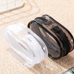 A transparent storage bag in clear and black with zippers, designed to hold various small items.