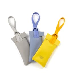 A set of three PVC leather glasses storage bags in grey, blue, and yellow, each with a looped strap and a logo.