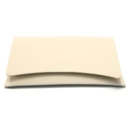 A cream hard shell eyeglasses case with a smooth finish and a curved flap design. Features a logo on the surface.