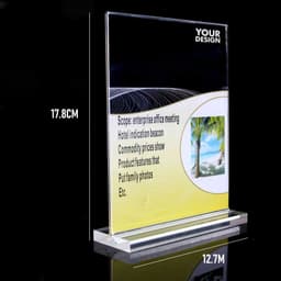 A clear acrylic table top sign holder measuring 17.8 cm high and 12.7 cm wide, featuring a base.