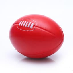 A red PU stress football with textured stitching details, designed for fun and relaxation.