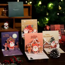 A collection of Christmas-themed 3D pop-up greeting cards in various colours, featuring festive designs and a pine cone.