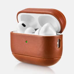 A vintage leather protective box in brown, holding white wireless headphones, with a small indicator light.