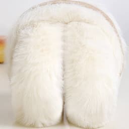 Fluffy white earmuffs with a soft texture and a band, designed for personalised winter wear.