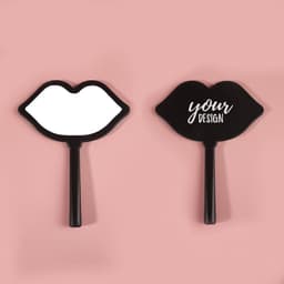 A lip-shaped hand mirror in black, featuring a smooth reflective surface on one side and a design space on the other.