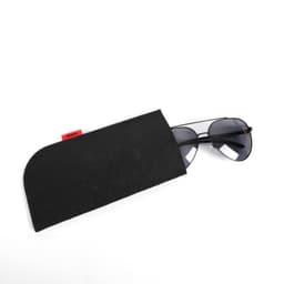 Polarised sunglasses in a black felt storage bag, featuring dark lenses and a simple design.