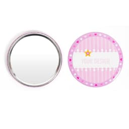 A round tinplate pocket mirror with a pink and white design, featuring a shiny reflective surface on one side.