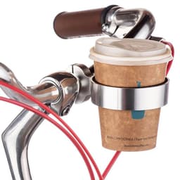 A drink bottle holder in silver, attached to a bike handlebar, holding a coffee cup wrapped in a cardboard sleeve.