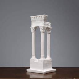 A white resin 3D model ornament featuring classical columns and a decorative arch, displayed on a wooden surface.