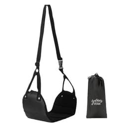 A black portable footrest with adjustable straps and a matching carry bag for storage.