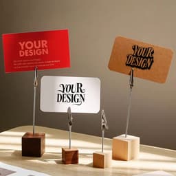 Three wooden alligator clip menu stands in various shapes, holding cards in red, white, and brown.