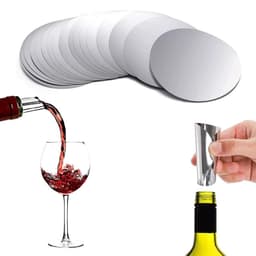 A set of circular silver wine pourer discs, alongside a glass of red wine and a pouring spout on a bottle.
