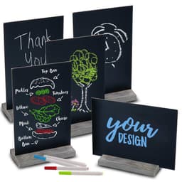 A set of tabletop chalkboard signs with wood bases in black, featuring various colourful chalk designs and markers.