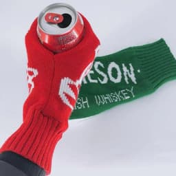 A drink bottle is held in a red and green crocheted mitten with a logo. The mittens feature fingerless designs.