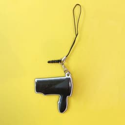 A black mobile phone screen cleaner keychain shaped like a hairdryer, attached to a black cord.
