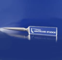 A clear 3D crystal letter opener with a pointed blade and a rectangular handle, featuring a logo.