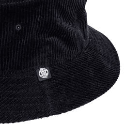 A black corduroy bucket hat featuring a logo on the side. The texture is clearly visible.