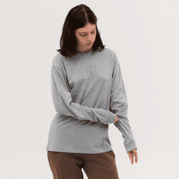 A grey long sleeve tee with a relaxed fit, featuring a round neckline and an attached logo.