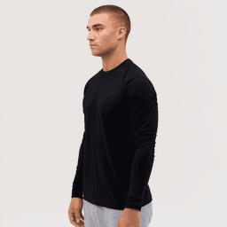 A black long sleeve tee displayed on a model, featuring a simple design and fitted silhouette.