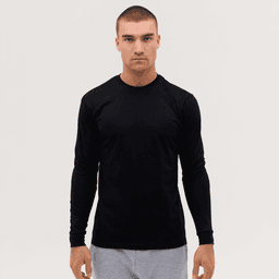 A long sleeve tee in black, featuring a fitted design and a logo, worn by a model against a plain background.