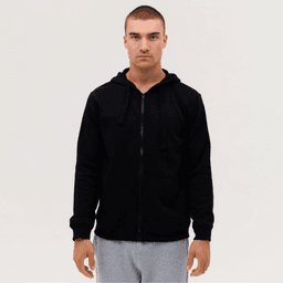 A black zip-up hoodie with a front pocket and adjustable hood, modelled by a person standing against a plain background.