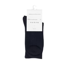 A pack of black bamboo socks, featuring a tag with care instructions and a logo.