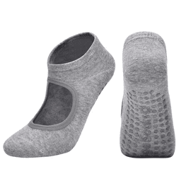 A pair of grey yoga socks with an open top and textured grip on the sole, featuring a logo.
